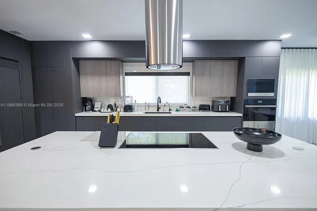 a large kitchen with stainless steel appliances