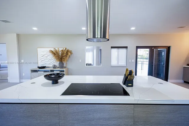 a view of a kitchen with a sink dishwasher refrigerator stove and wooden floor