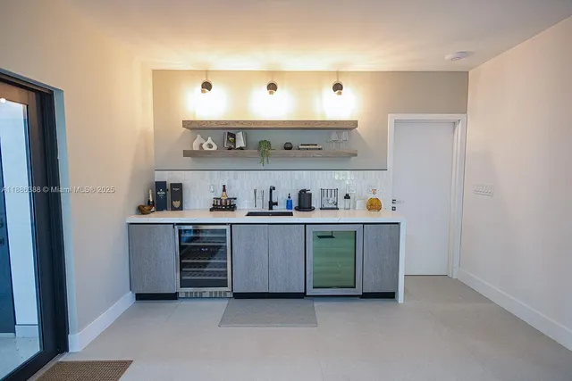 a kitchen with stainless steel appliances a sink and cabinets