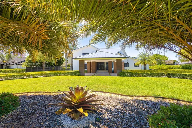 a front view of a house with swimming pool