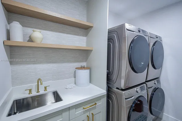 a utility room with sink dryer and washer