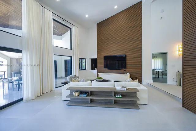 a living room with furniture pool table and flat screen tv
