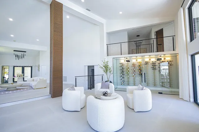 a bedroom with furniture and large windows