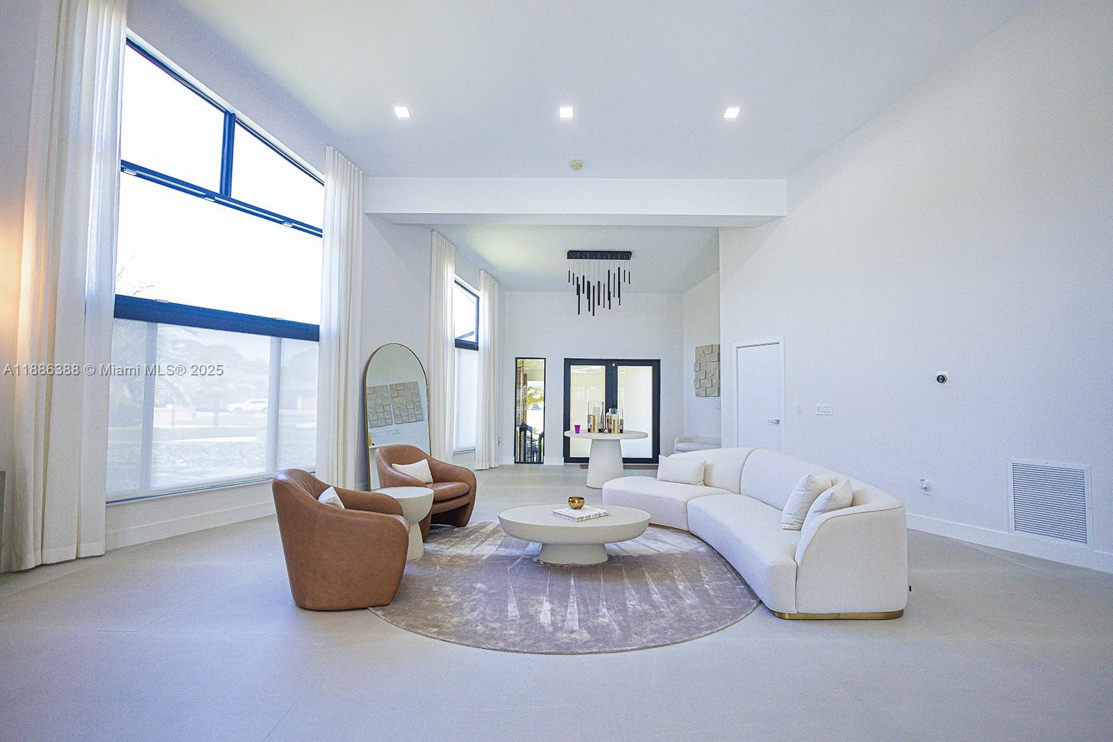 10506 Southwest 89th Place Miami, FL 33176 - Photo 30 of 51 a living room with furniture a large window and a chandelier