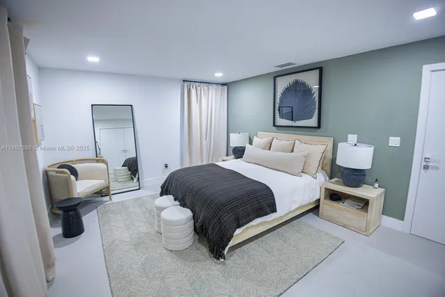 a bedroom with a bed and a painting on the wall