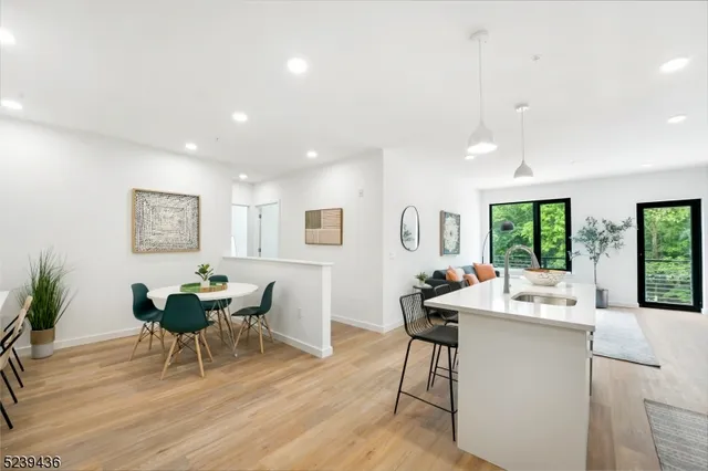 a living room with furniture a window and wooden floor
