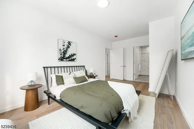 a bed sitting in a bedroom next to a wooden floor