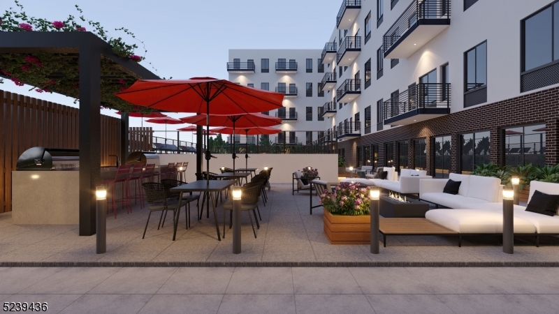 803 South Avenue, Unit 510 Plainfield, NJ 07062 - Photo 29 of 47 a view of a patio with a table and chairs under an umbrella