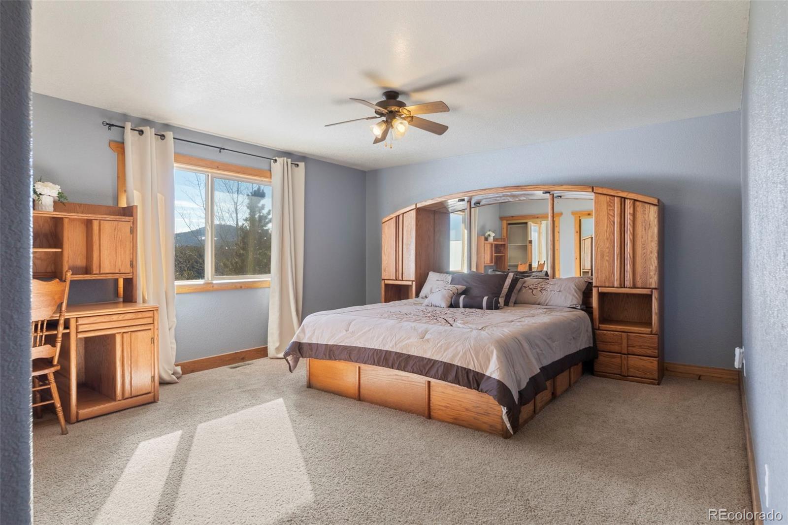 412 Evergreen Road Black Hawk, CO 80422 - Photo 41 of 48 a spacious bedroom with a bed and a large window