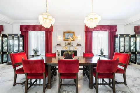 a view of a dining room with furniture and a chandelier