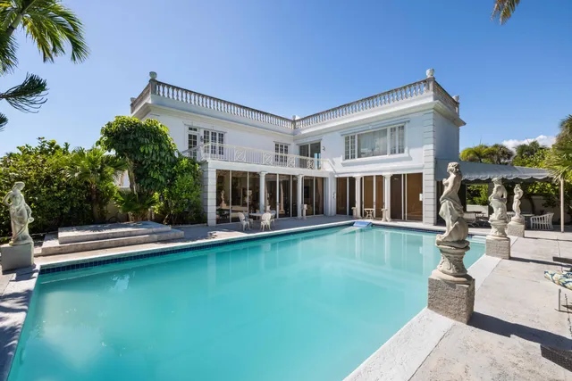 a view of an house with swimming pool and porch