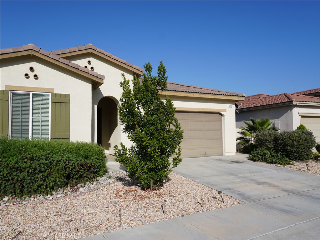 348 Scarlett Runner Beaumont, CA 92223 - Photo 13 of 33 front view of a house with a small yard