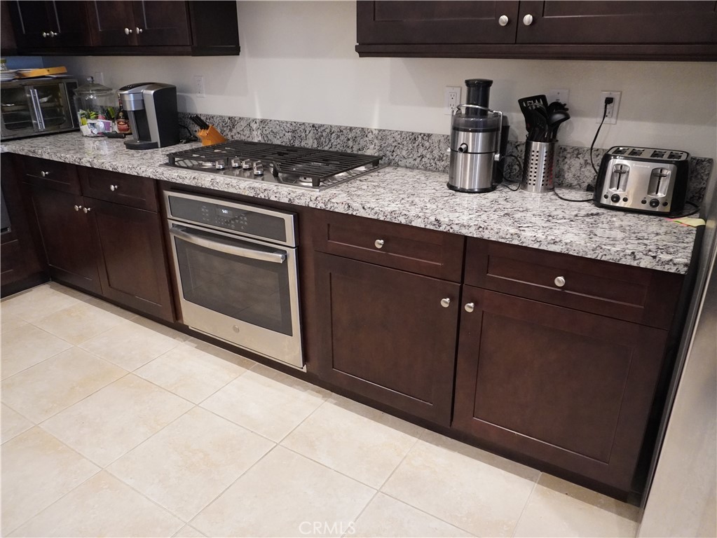 348 Scarlett Runner Beaumont, CA 92223 - Photo 19 of 33 a kitchen with granite countertop a stove and a sink
