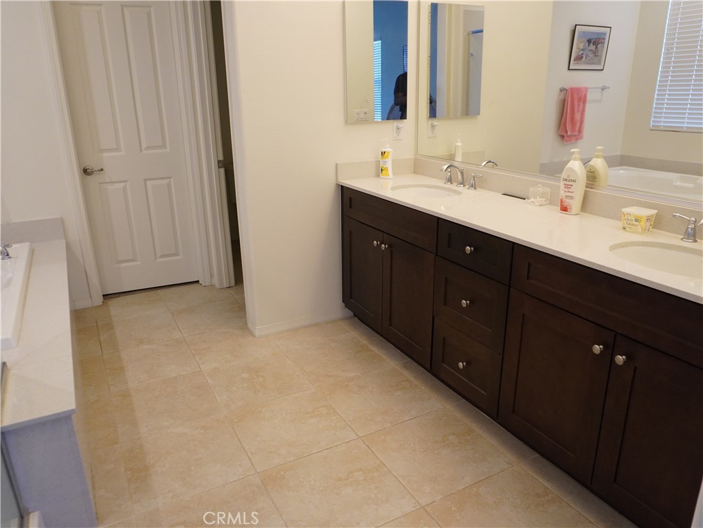 348 Scarlett Runner Beaumont, CA 92223 - Photo 25 of 33 a bathroom with a double vanity sink and mirror