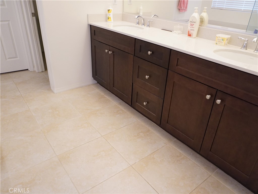 348 Scarlett Runner Beaumont, CA 92223 - Photo 26 of 33 a bathroom with a double vanity sink and mirror