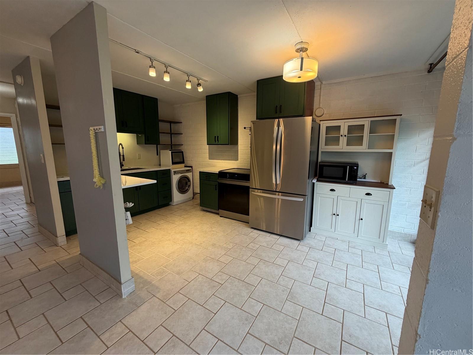 45-535 Luluku Road, Unit G1 Kaneohe, HI 96744 - Photo 4 of 15 a kitchen with stainless steel appliances a refrigerator and a sink