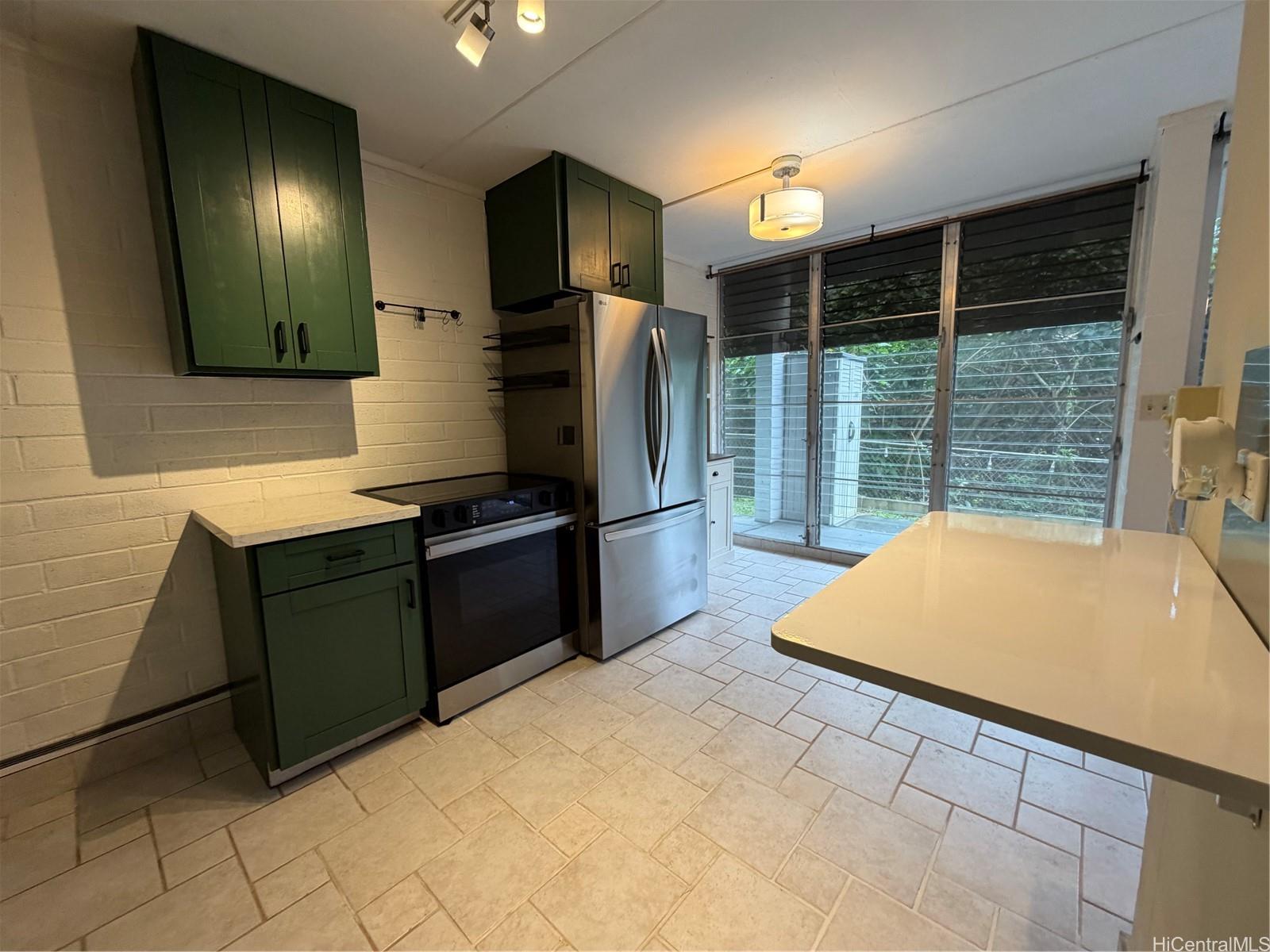 45-535 Luluku Road, Unit G1 Kaneohe, HI 96744 - Photo 5 of 15 a kitchen with a refrigerator and a sink