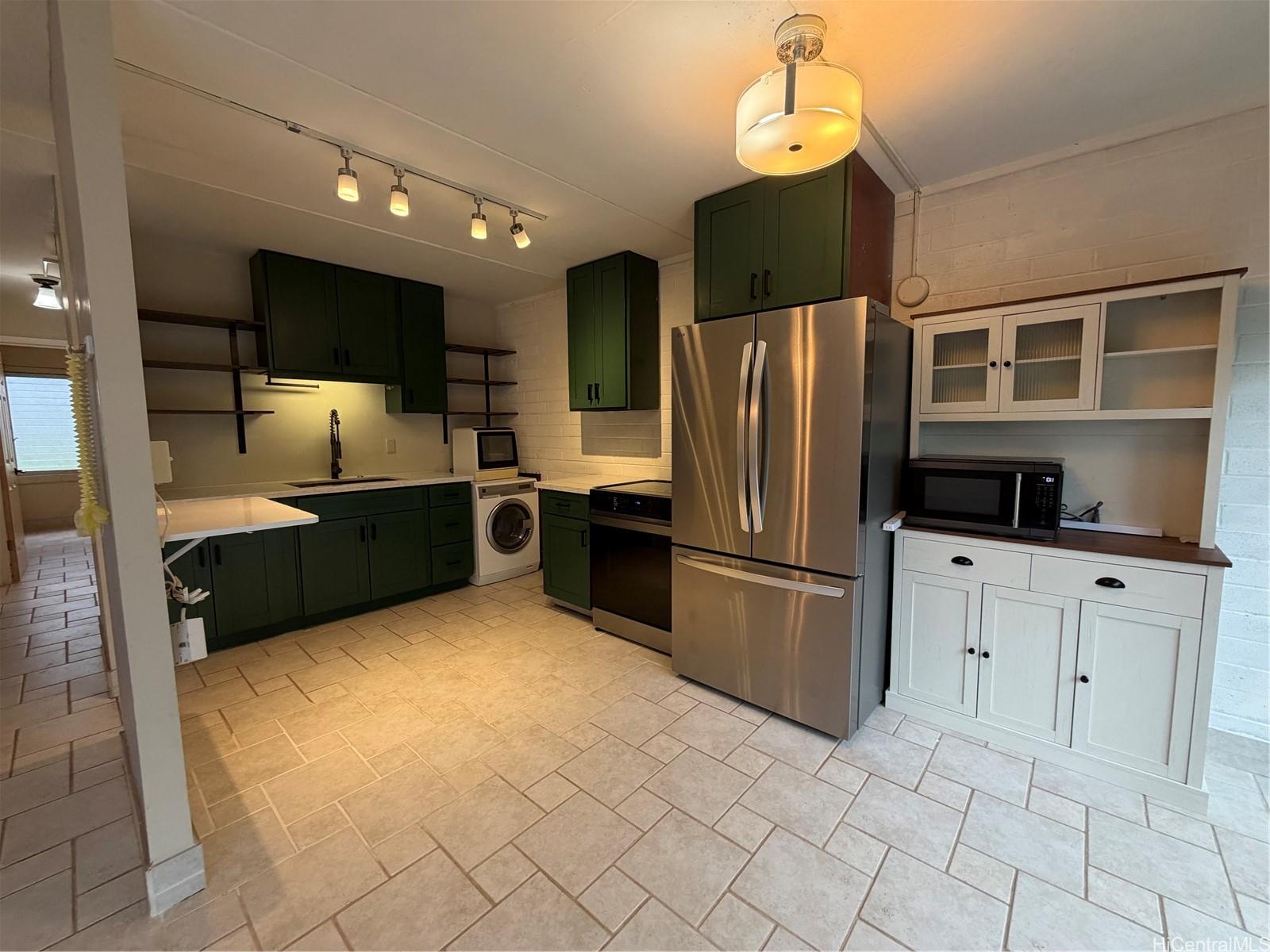 45-535 Luluku Road, Unit G1 Kaneohe, HI 96744 - Photo 6 of 15 a kitchen with stainless steel appliances a refrigerator sink and cabinets