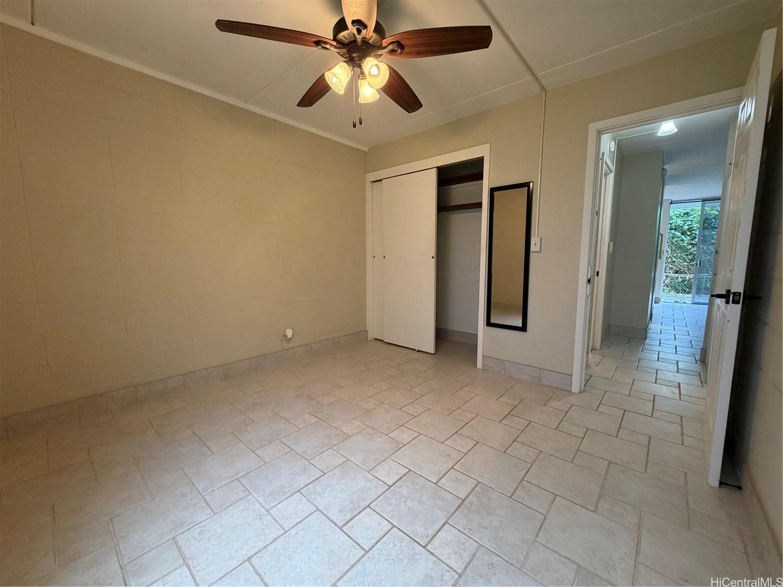 45-535 Luluku Road, Unit G1 Kaneohe, HI 96744 - Photo 8 of 15 an empty room with closet and a chandelier fan