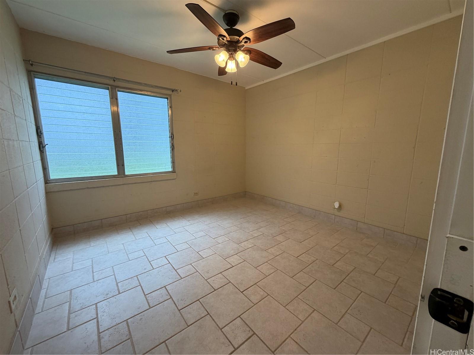45-535 Luluku Road, Unit G1 Kaneohe, HI 96744 - Photo 9 of 15 an empty room with windows and fan
