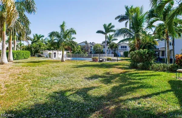 a swimming pool with outdoor seating and yard