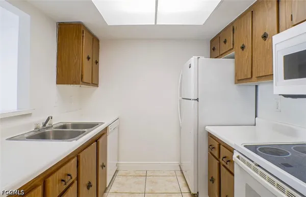 a kitchen with a sink and a refrigerator