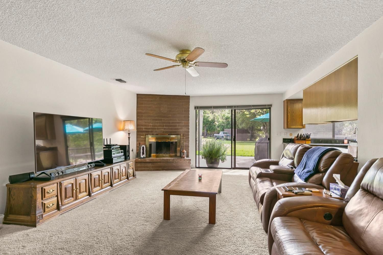 218 Sierra Road Ojai, CA 93023 - Photo 15 of 50 a living room with furniture a flat screen tv and a fireplace