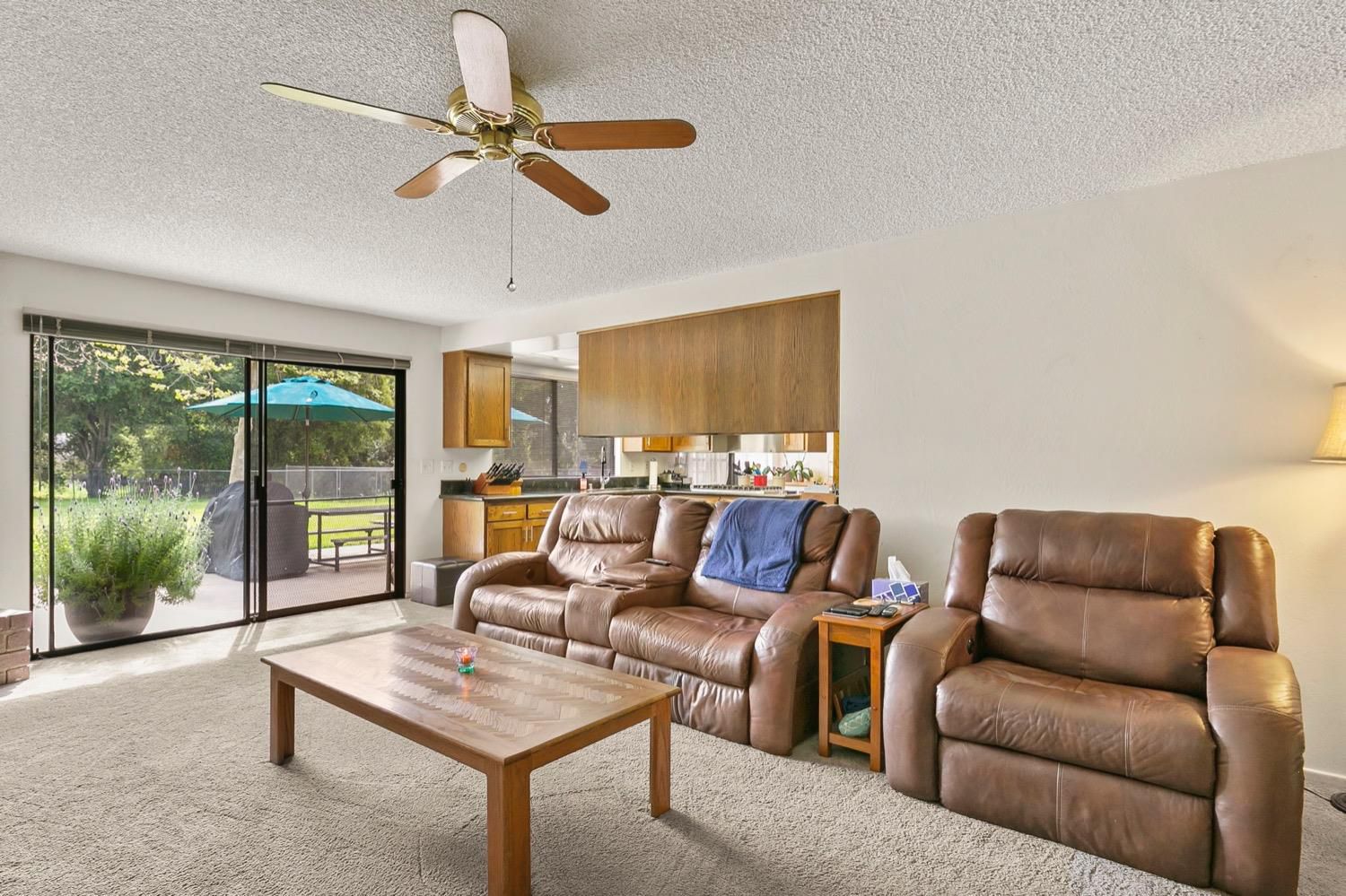218 Sierra Road Ojai, CA 93023 - Photo 16 of 50 a living room with furniture a ceiling fan and a floor to ceiling window