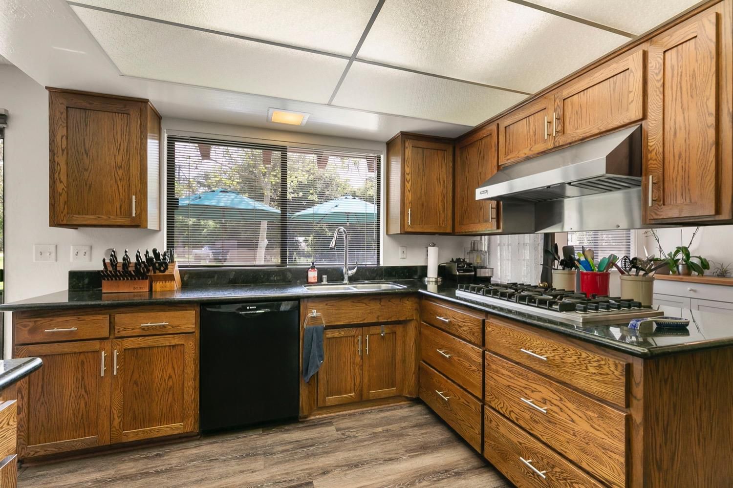 218 Sierra Road Ojai, CA 93023 - Photo 20 of 50 a kitchen with stainless steel appliances granite countertop wooden cabinets sink stove and granite counter top