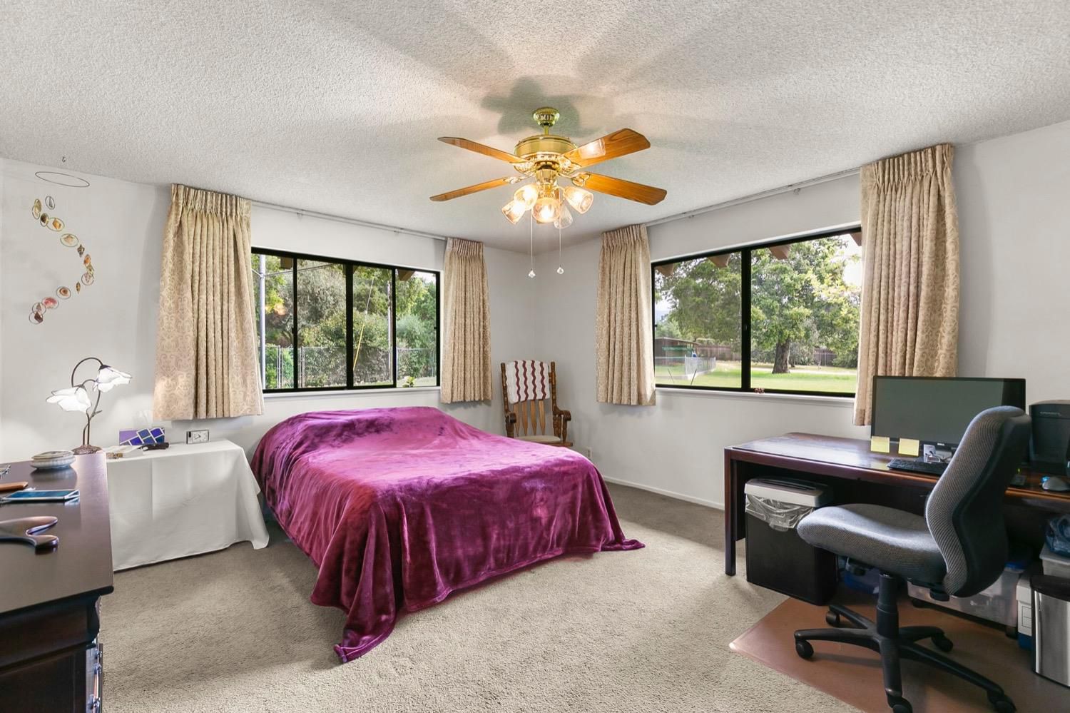 218 Sierra Road Ojai, CA 93023 - Photo 24 of 50 a bedroom with a bed and a chandelier