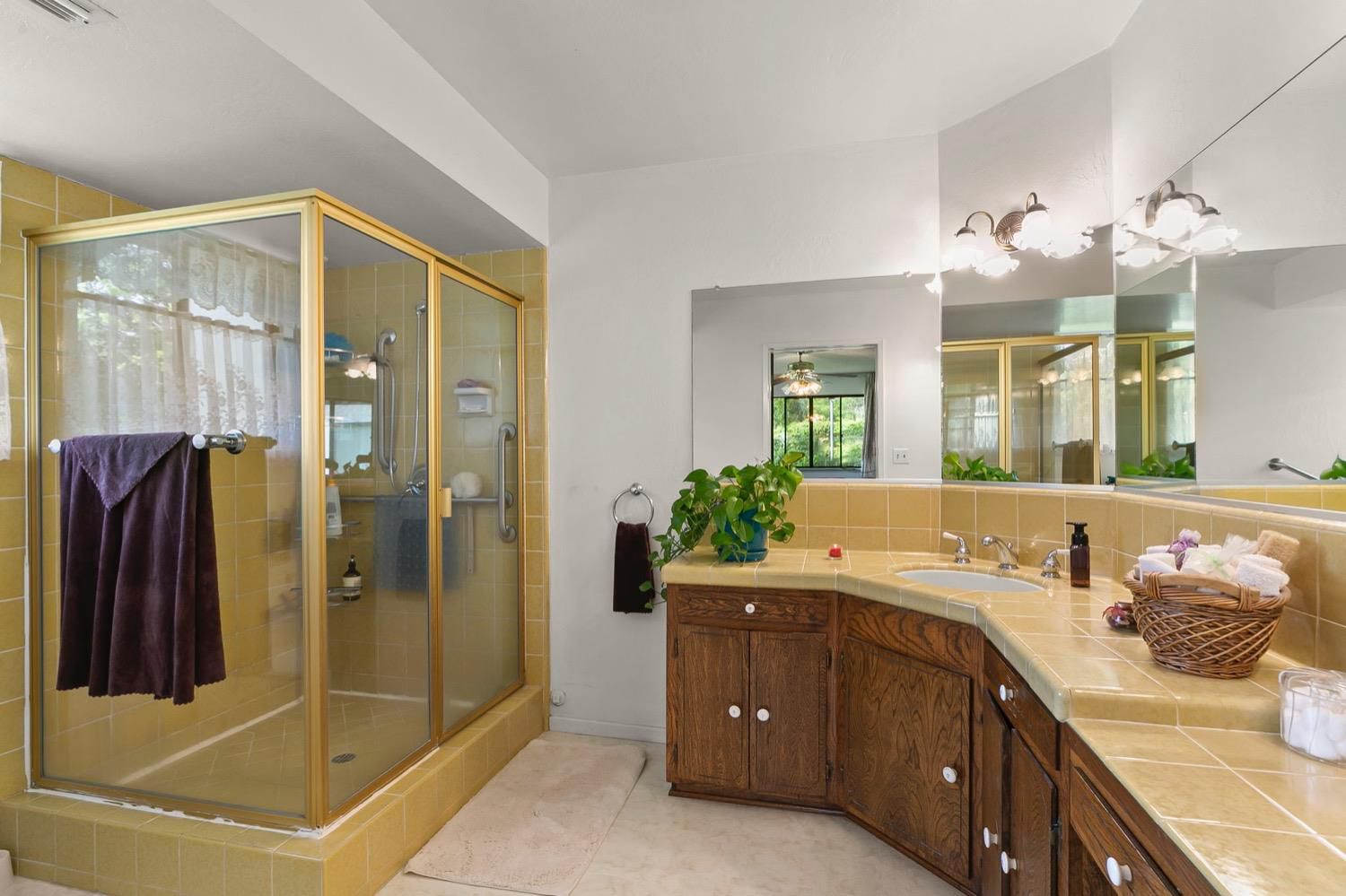 218 Sierra Road Ojai, CA 93023 - Photo 26 of 50 a spacious bathroom with a granite countertop sink mirror and shower