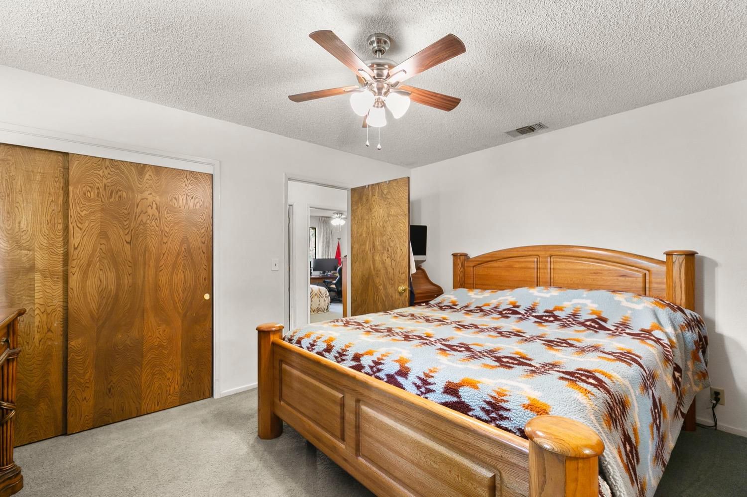 218 Sierra Road Ojai, CA 93023 - Photo 28 of 50 a bedroom with a bed and a chandelier