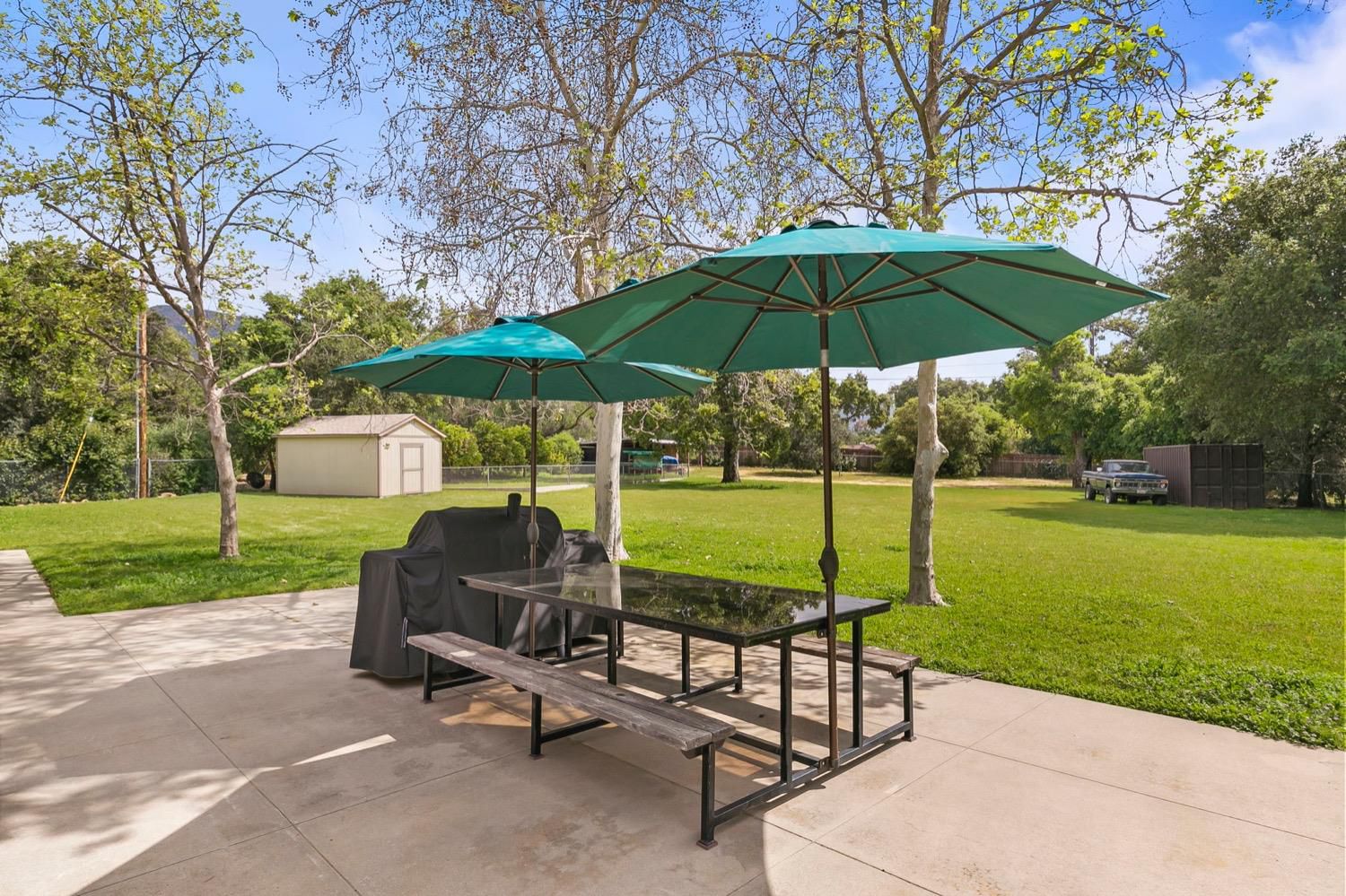 218 Sierra Road Ojai, CA 93023 - Photo 34 of 50 a view of a garden with a table and chairs under an umbrella