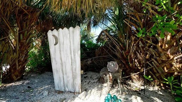 an aerial view of residential houses with outdoor space and ocean view