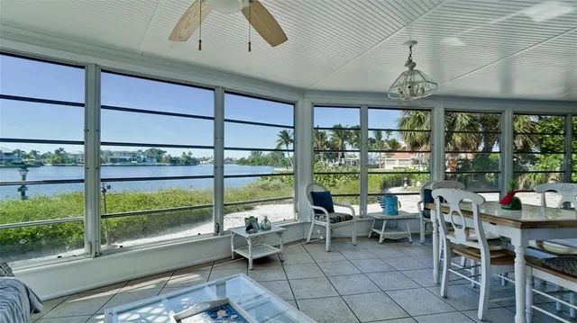 an aerial view of a house with a garden and lake view