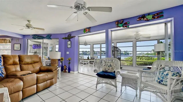 a living room with furniture a chandelier and a window