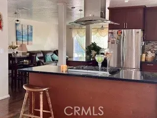 a kitchen with stainless steel appliances granite countertop a sink a stove and a refrigerator