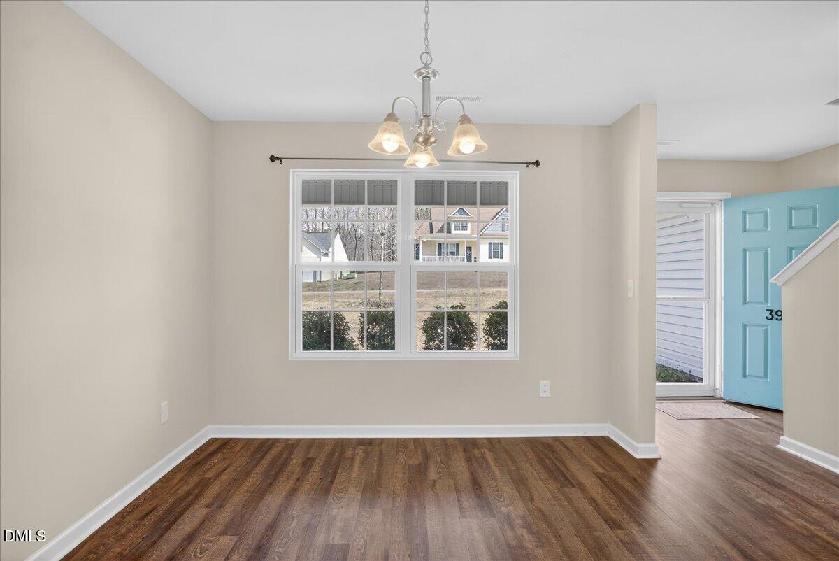 399 West Waycliff Road Henderson, NC 27537 - Photo 8 of 69 a view of an empty room with wooden floor and a window