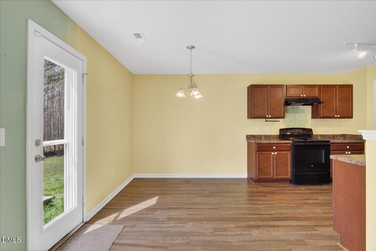 399 West Waycliff Road Henderson, NC 27537 - Photo 10 of 69 a kitchen with stainless steel appliances granite countertop a stove a sink and a refrigerator