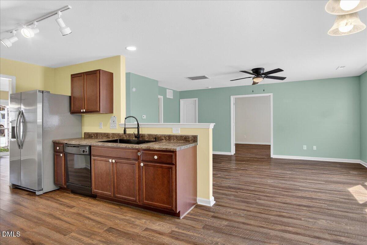 399 West Waycliff Road Henderson, NC 27537 - Photo 11 of 69 a kitchen with stainless steel appliances granite countertop a sink and wooden cabinets
