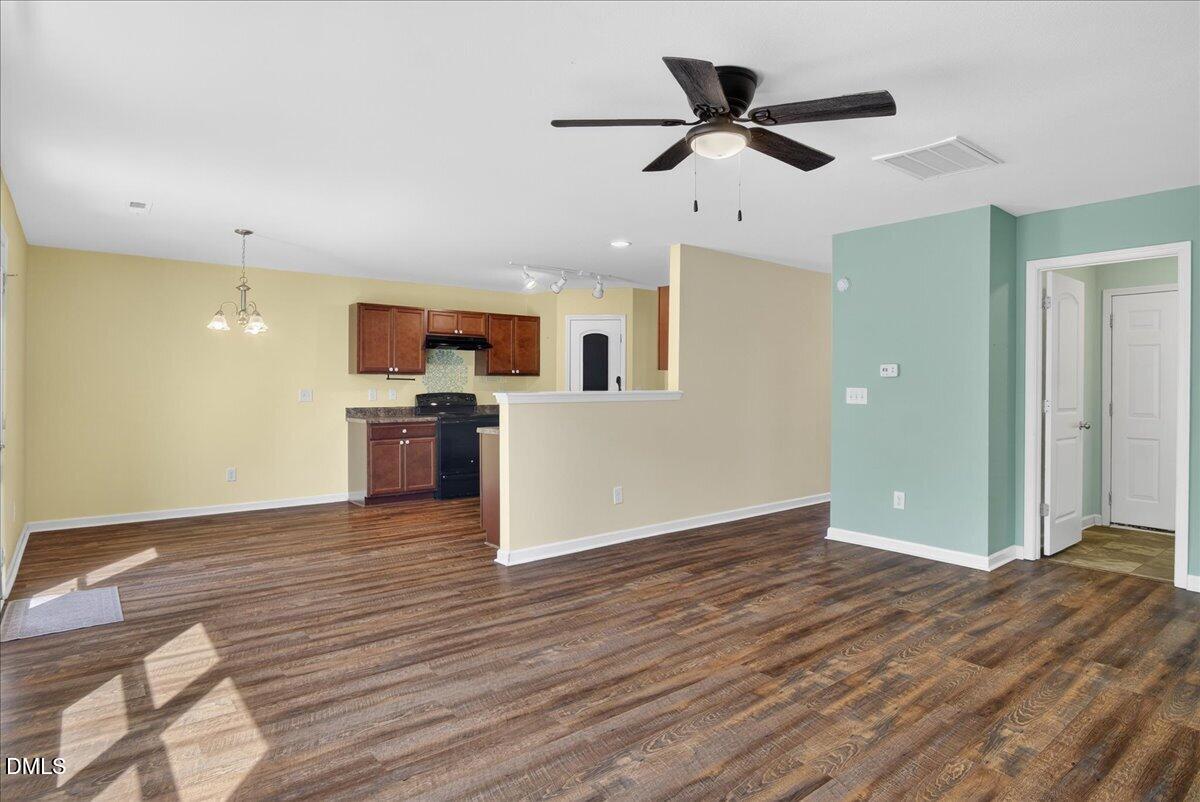 399 West Waycliff Road Henderson, NC 27537 - Photo 15 of 69 a view of empty room with wooden floor and ceiling fan