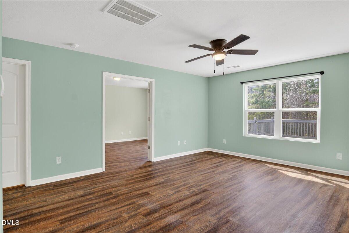 399 West Waycliff Road Henderson, NC 27537 - Photo 16 of 69 a view of an empty room with wooden floor and a window