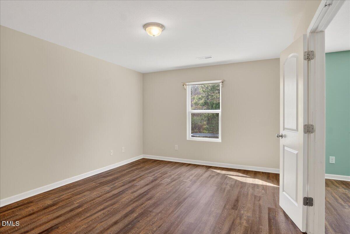 399 West Waycliff Road Henderson, NC 27537 - Photo 19 of 69 an empty room with wooden floor and windows