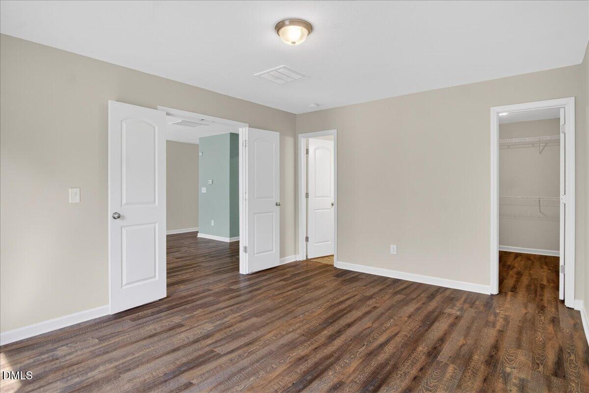 399 West Waycliff Road Henderson, NC 27537 - Photo 22 of 69 a view of an empty room with wooden floor and a window