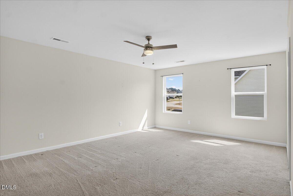 399 West Waycliff Road Henderson, NC 27537 - Photo 27 of 69 an empty room with windows and ceiling fan