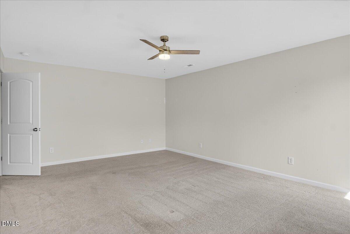 399 West Waycliff Road Henderson, NC 27537 - Photo 30 of 69 an empty room with a ceiling fan and a window