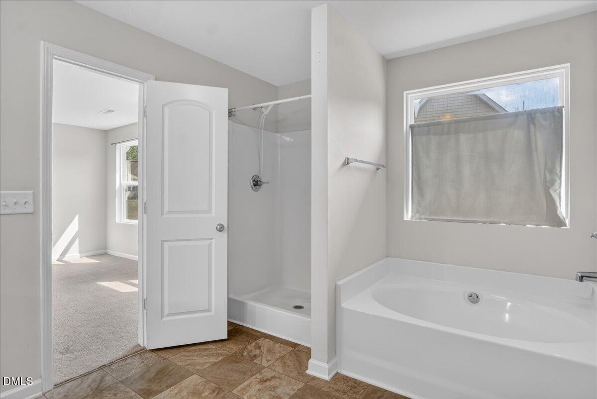 399 West Waycliff Road Henderson, NC 27537 - Photo 32 of 69 a bathroom with a bathtub and a shower