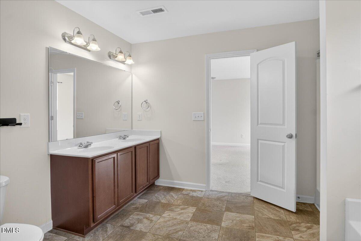 399 West Waycliff Road Henderson, NC 27537 - Photo 33 of 69 a bathroom with a sink vanity and mirror
