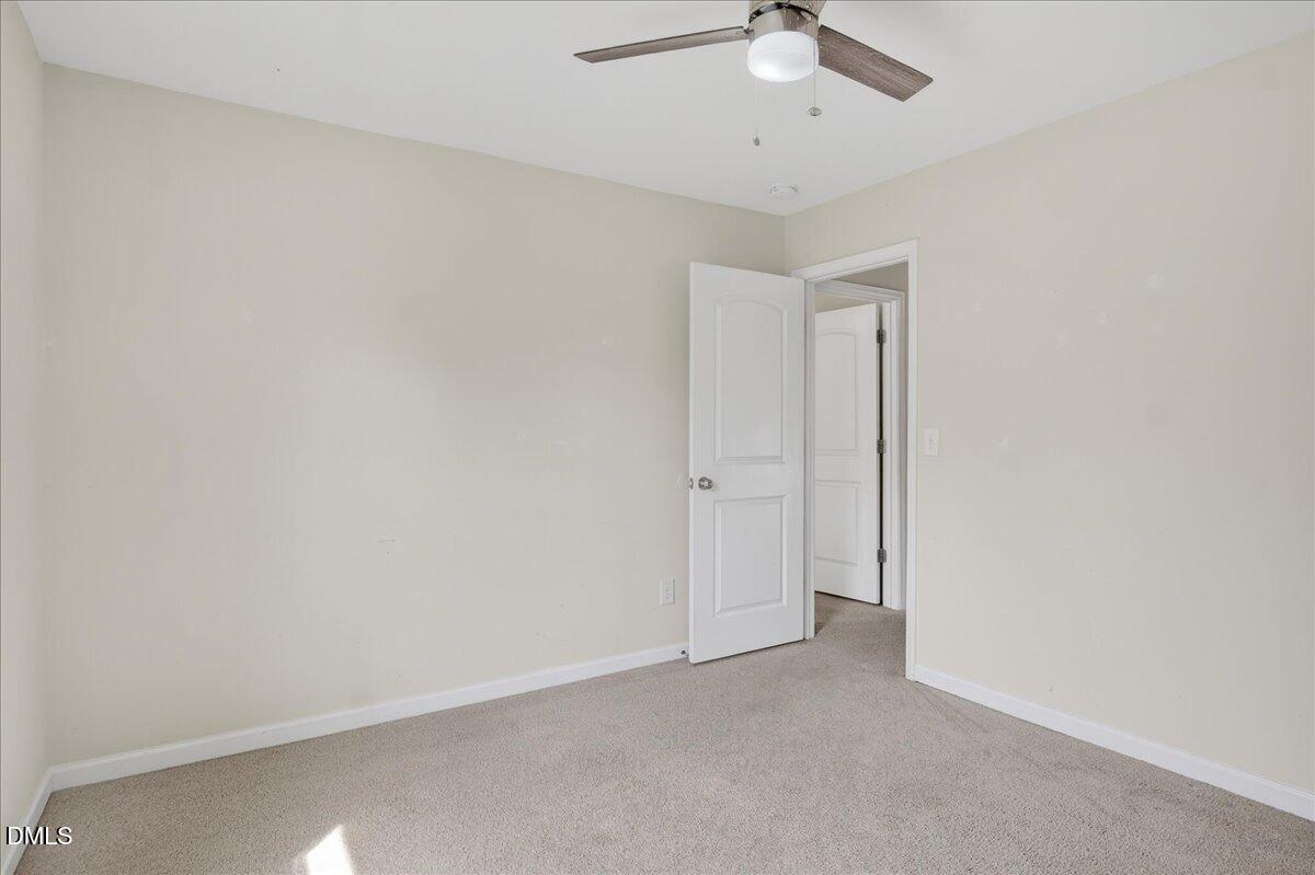 399 West Waycliff Road Henderson, NC 27537 - Photo 37 of 69 an empty room with a ceiling fan and a window