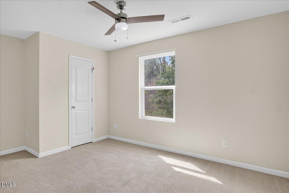 399 West Waycliff Road Henderson, NC 27537 - Photo 39 of 69 an empty room with a window and a fan